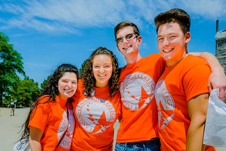 a group of freshman students wearing orange LCC branded shirts