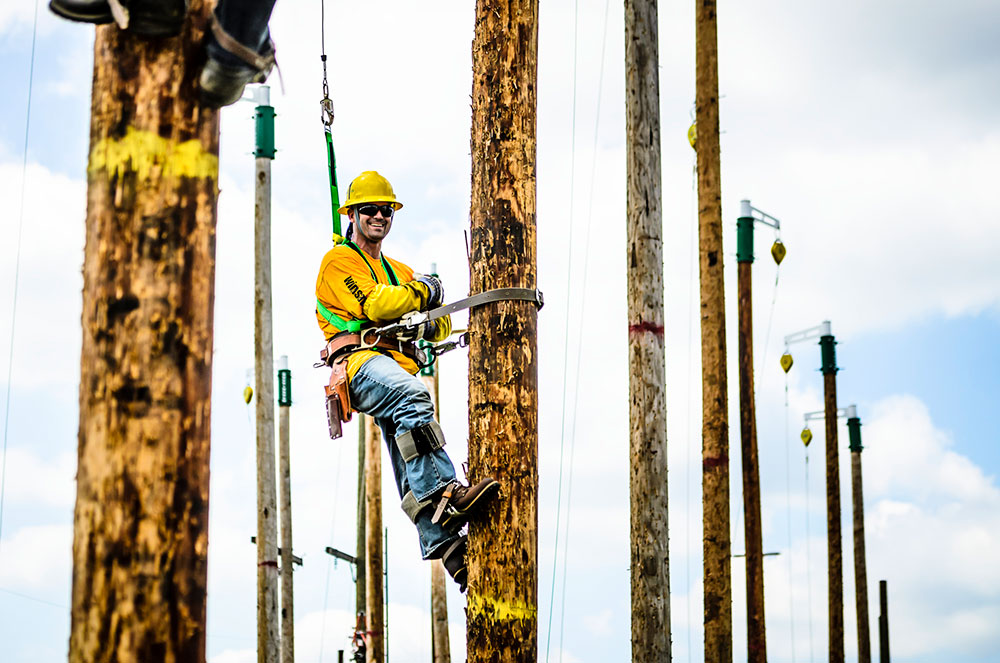 student up on one of the lcc training utility poles at west campus