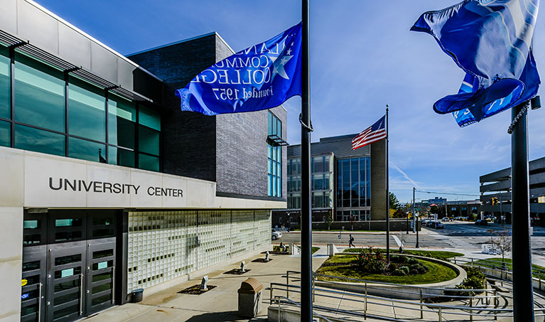 LCC flags fly outside of the University Center entrance