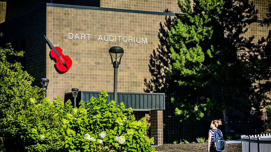 A student walks by the entrance to the Dart Auditorium