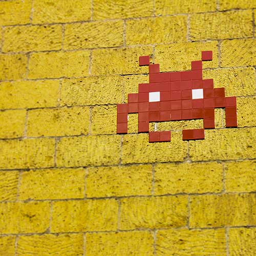 Video game icon on brick wall