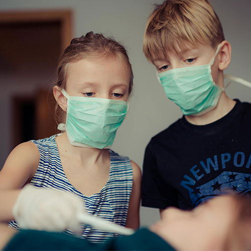 Students wearing masks while inspecting patient