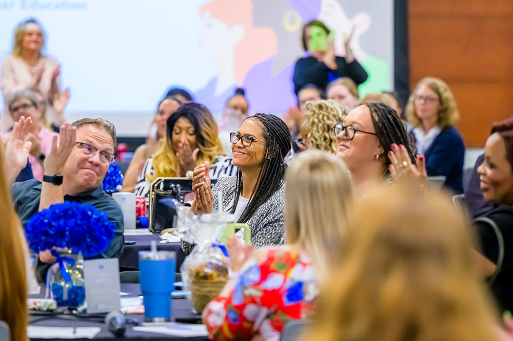 group of people clapping at an event