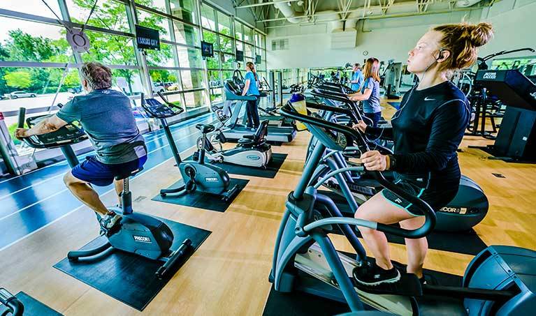woman riding elptical at west campus fitness center