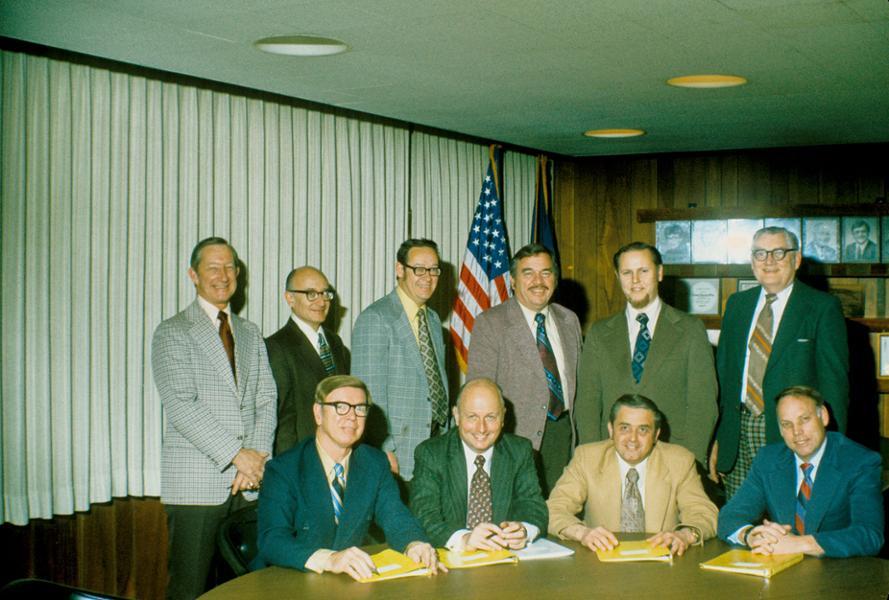 President Gannon with Trustees and Division Heads in an old Boardroom.