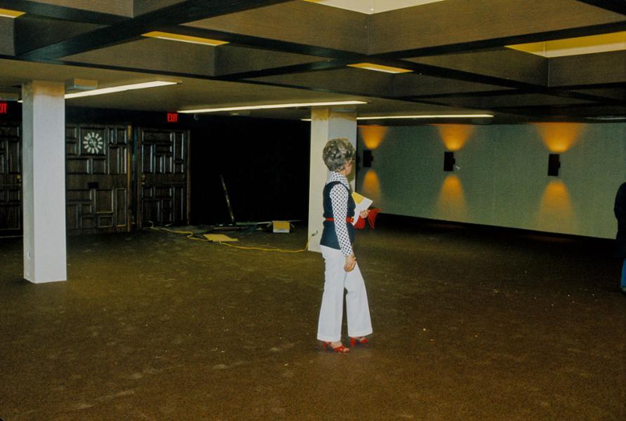 A woman walks through an empty room on the mezzanine level in the Old Central Building.