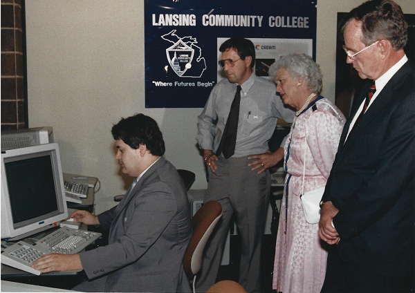 Vice President George H. W. Bush and Barbara Bush watch an LCC employee demonstrate computer equipment.