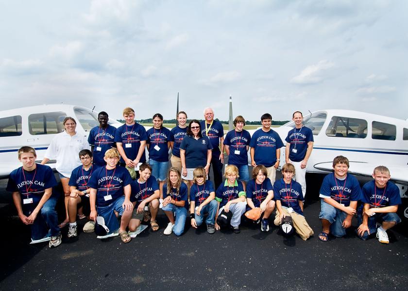 Participants in the 2006 youth Aviation Camp pose by two Piper Cherokee Warrior airplanes.