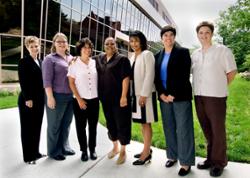 President Cunningham stands with the staff of the Women's Resource Center/Returning Adult Program and the Beverly Hunt Award winner outside the HHS Building.