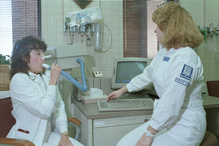 A Respiratory Therapy student from the LCC Department of Health Careers practices using equipment with another student. - ca. 1980s