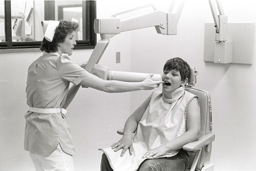 A Dental Hygiene student taking an x-ray in the Dental Clinic in the Arts and Sciences Building - ca. 1980s