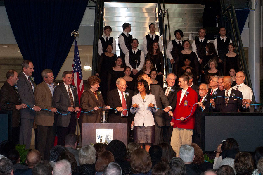 President Cunningham (center) prepares to connect the power at the Grand Opening of LCC's West Campus. Helping her hold the power cord are several city, state and LCC dignitaries including U.S. Senator Debbie Stabenow (5th from left), U.S. Senator Carl Levin (6th from left), U.S. Representative Mike Rogers (behind President Cunningham), Joseph Reid (7th from right), Lansing Mayor Tony Benavides (5th from right), Trustee Chris Laverty (4th from right), President Philip Gannon (behind 2nd from right), President Abel Sykes, Jr. (2nd from right) - November 2004