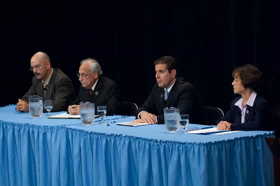 Candidates face the audience at the Lansing Mayoral Debate held at Dart Auditorium in 2005. Seated second from left is Antonio (Tony) Benavides, Lansing mayor from 2003 to 2006, and second from the right is Virgil (Virg) Bernero, Lansing mayor from 2006 to 2018.