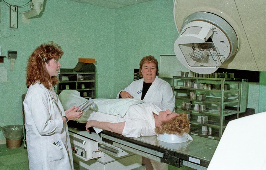 A Radiologic Technology Student from the LCC Department of Health Careers and an instructor operate equipment over a patient - May 1988