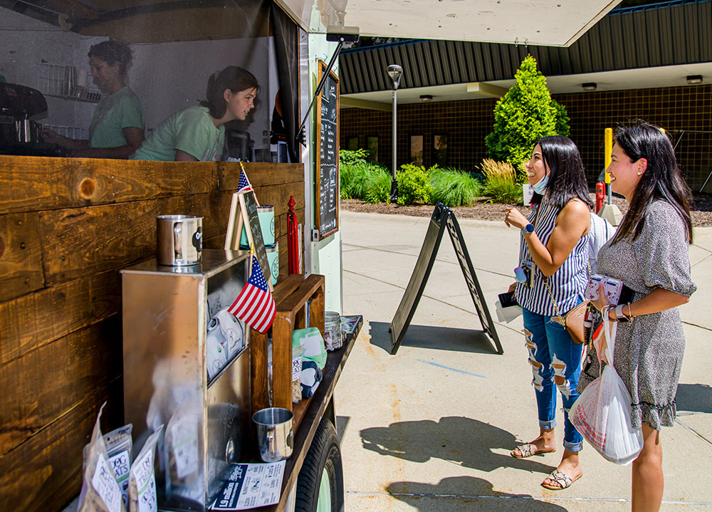 students ordering food at food trucks on campus