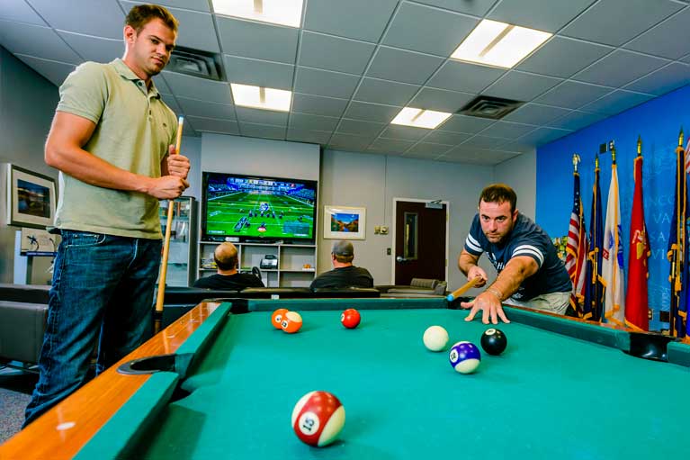 veteran students playing pool in resource center 