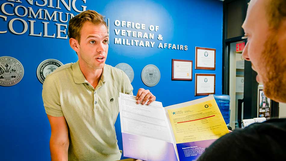 Advisor explains paperwork at the Office of Veteran & Military Affairs