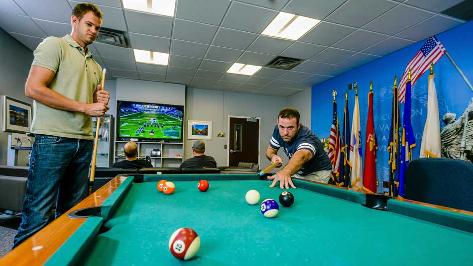 Students play pool and video games in the VRC lounge