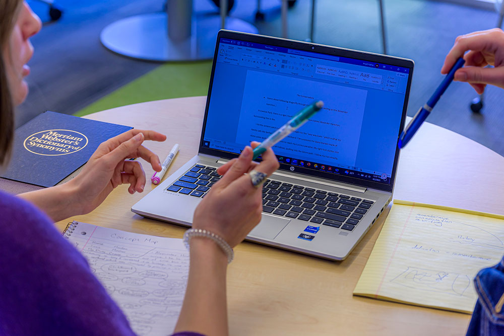 a student receiving support while on a laptop